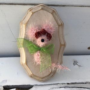 Crocheted tiny mouse on a wood plaque
